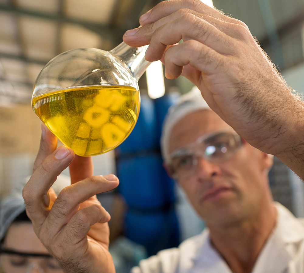 Scientist in lab holding beaker